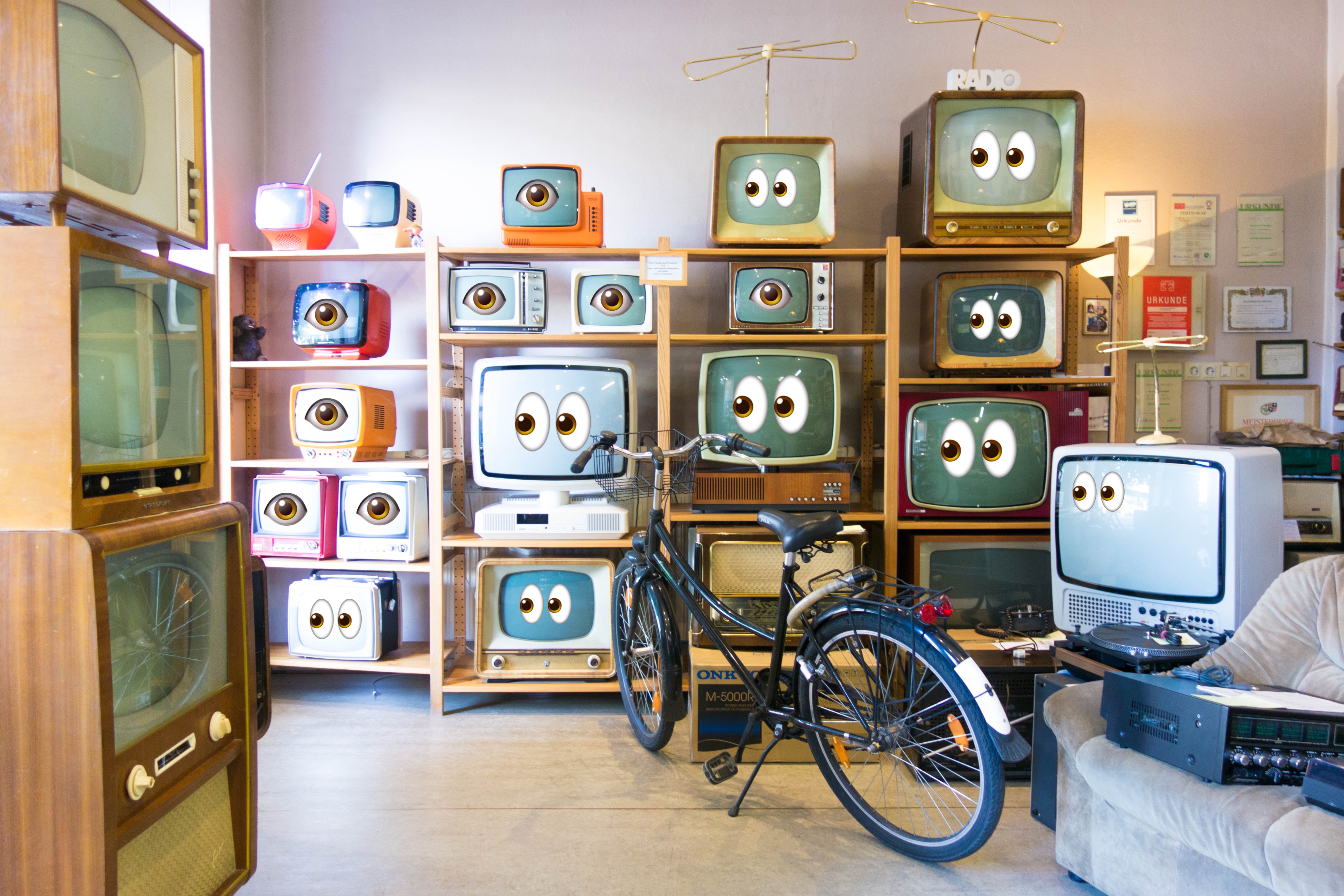 a bunch of TVs with emoji eyes